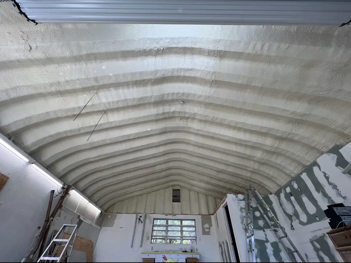 Spray polyurethane foam applied to the underside of a metal roof deck in Colton